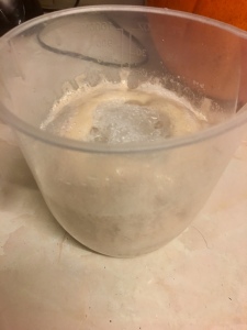 Yeast being activated in a plastic measuring jug